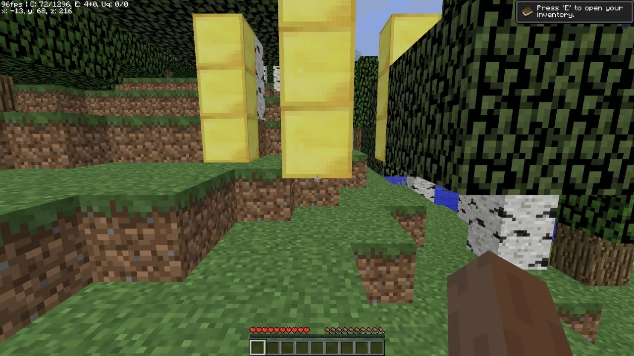Restored Minecraft world showing the emerald and gold marker blocks intact after restoring the backup snapshot.